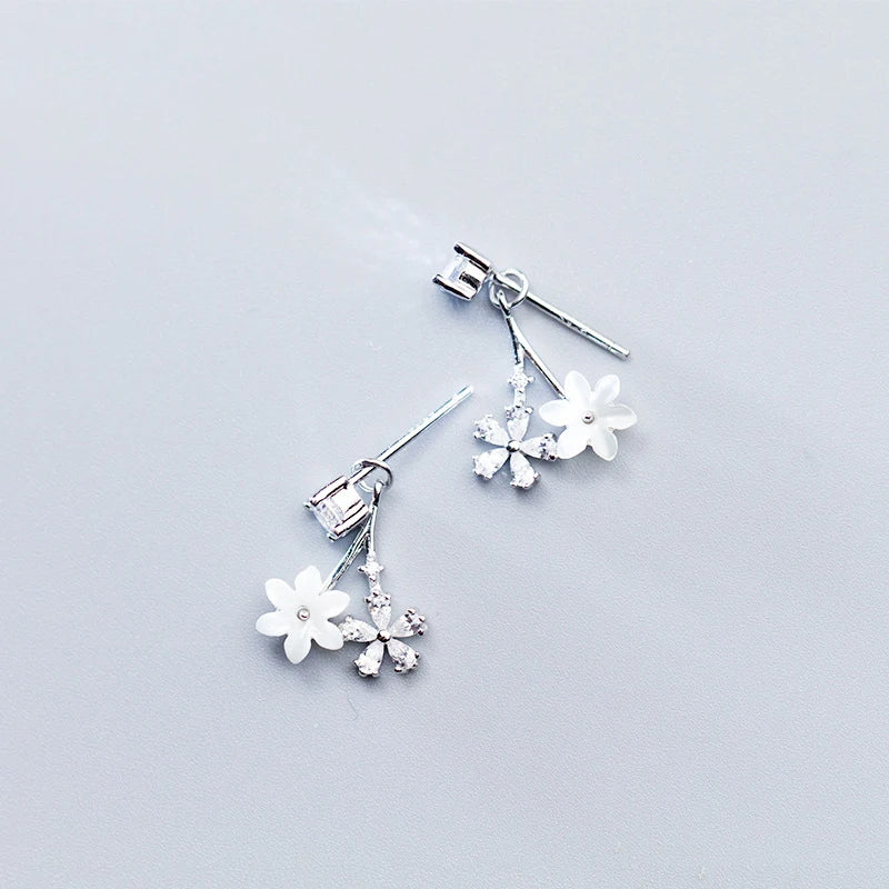 Close view of sterling silver earrings showing refined flower detail