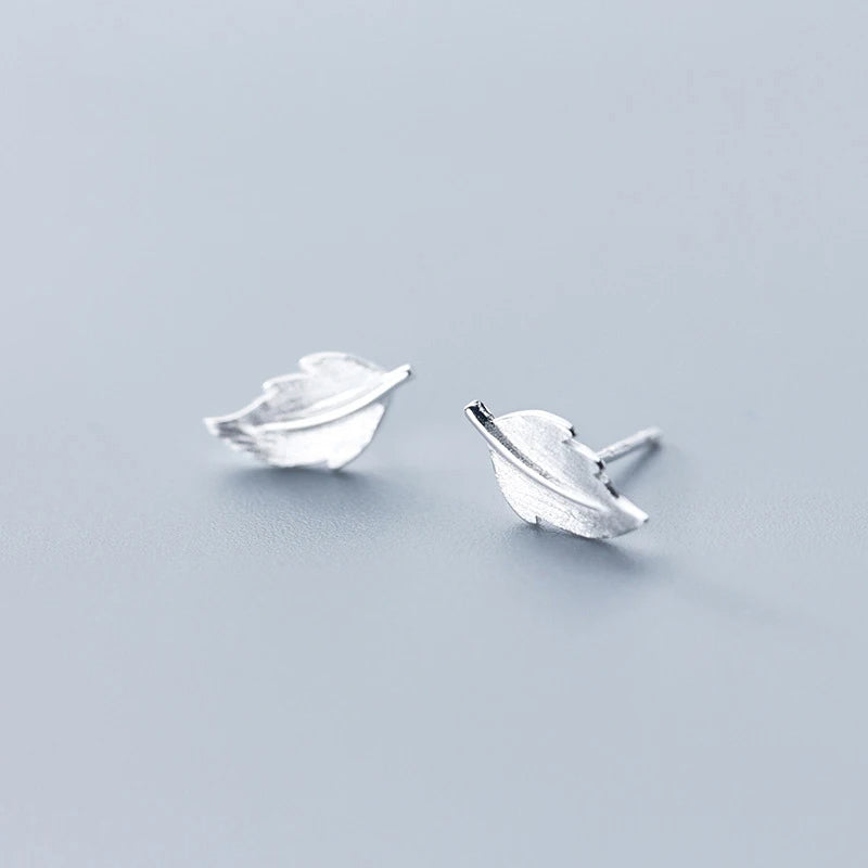 Leaf earrings in silver color styled as stud earrings for women