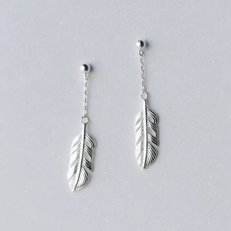 Ear rings showing delicate tree leaves and refined drop earrings lines