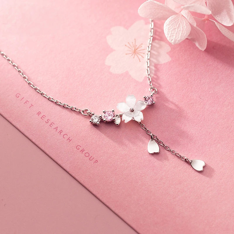 Sterling silver necklace featuring a delicate flower necklace charm and pendant necklace drop
