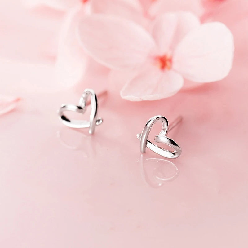 Sterling silver earrings with a heart design in stud earrings style