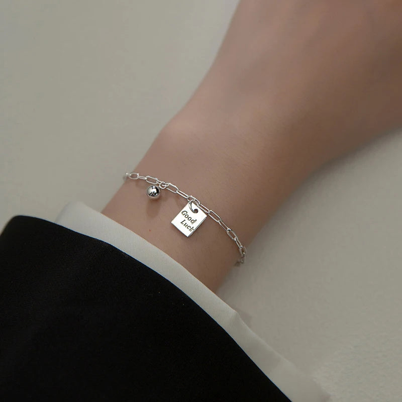 Chain bracelet styled as a sleek silver bangle