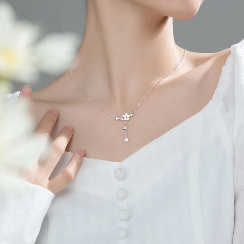 Sterling silver chain supporting a refined flower necklace with subtle shine