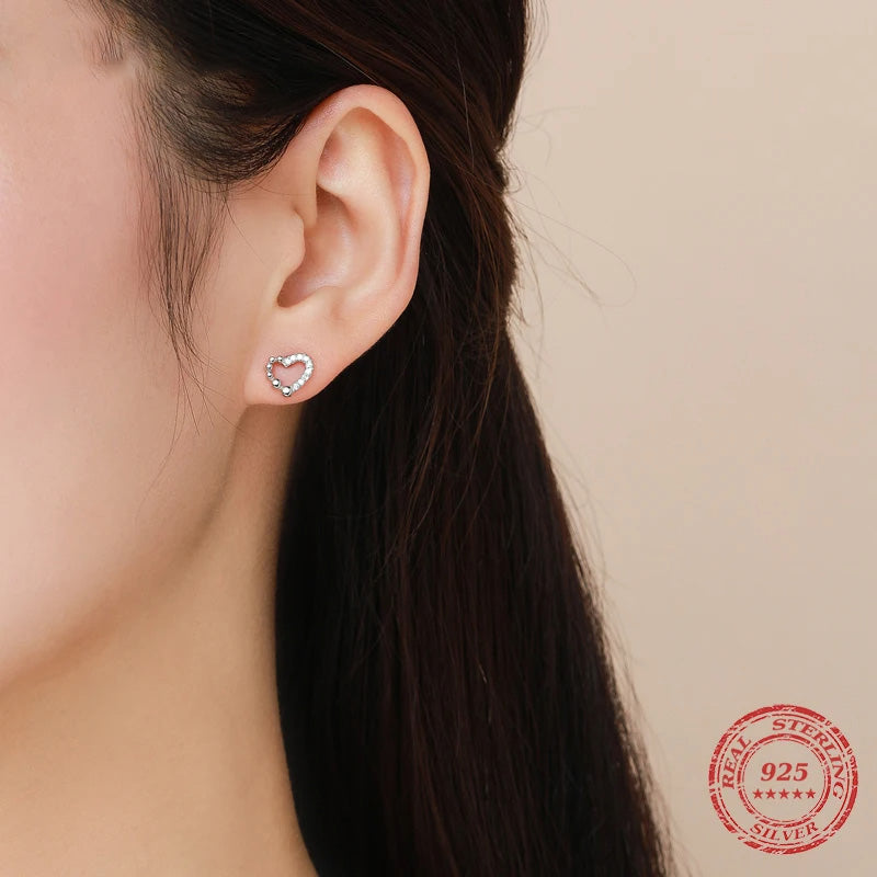 Heart earrings styled as silver earrings for women with a whimsical heart motif