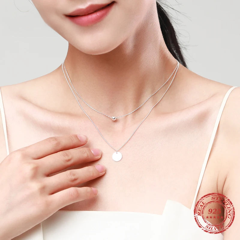 Layer necklace pairing shown with a fine chain necklace