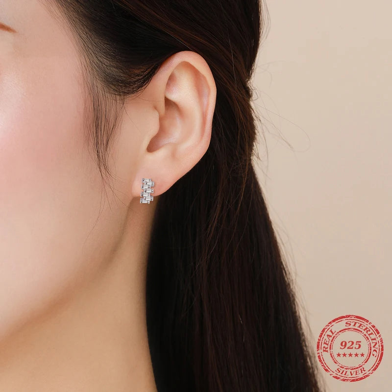 Sterling silver earrings showcasing a crisp emerald cut design