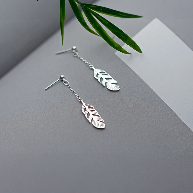 Sterling silver tree leaves design styled as elegant dangle earrings