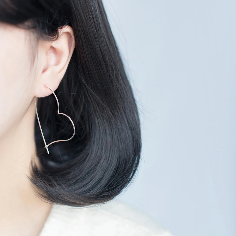 Heart earrings styled as sterling silver hoop earrings