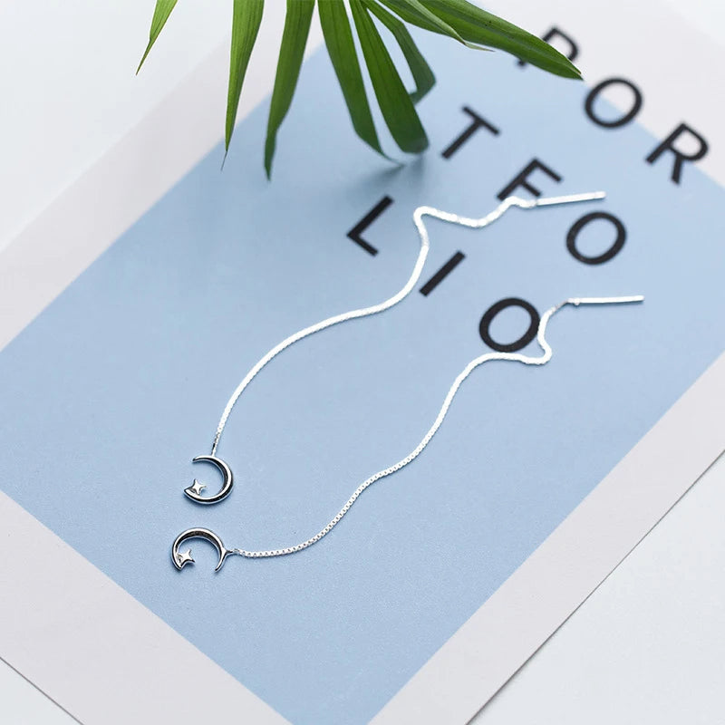Delicate dangle earrings with dream moon detail and ch ain flow