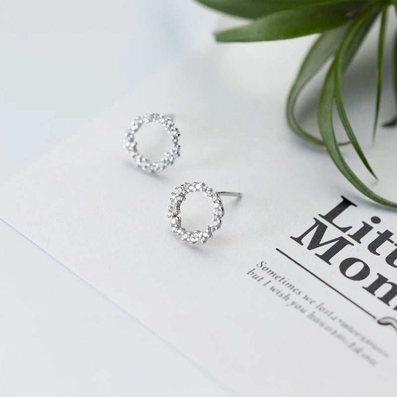 Sterling silver earrings featuring geometric cz and delicate rose gold accents