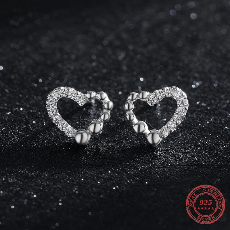 Silver earrings with whimsical heart design and subtle cz shimmer