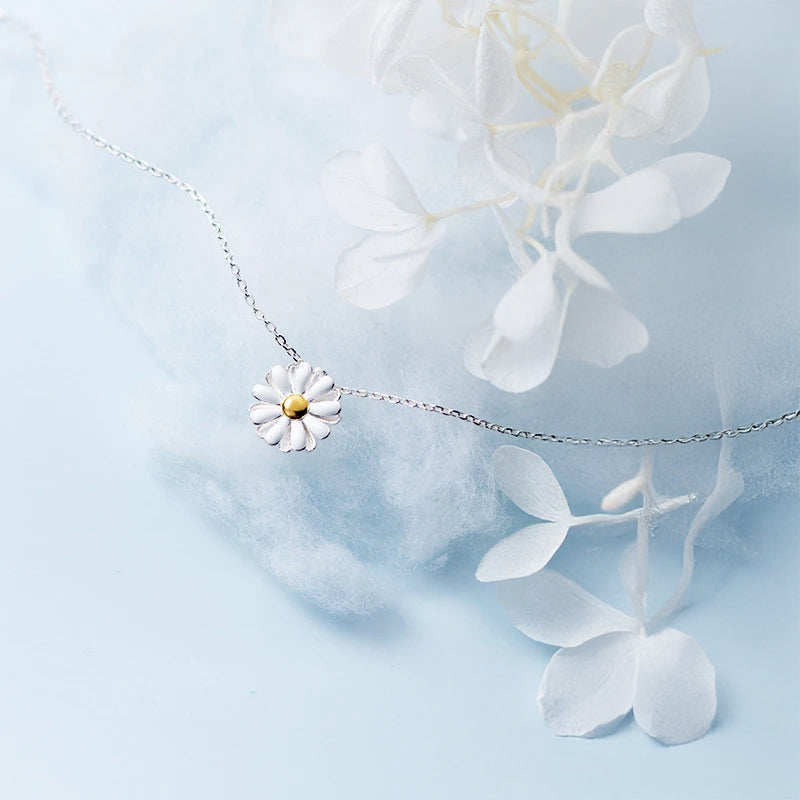 Sterling silver chain holding a refined flower necklace pendant