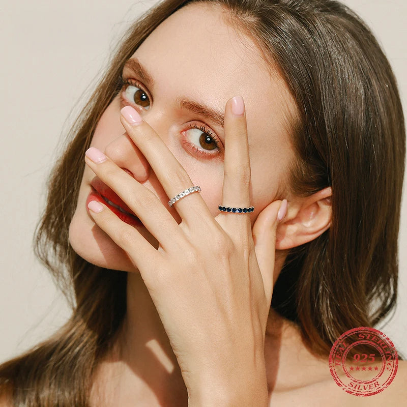Sleek sterling silver ring styled as a stackable ring with subtle shine