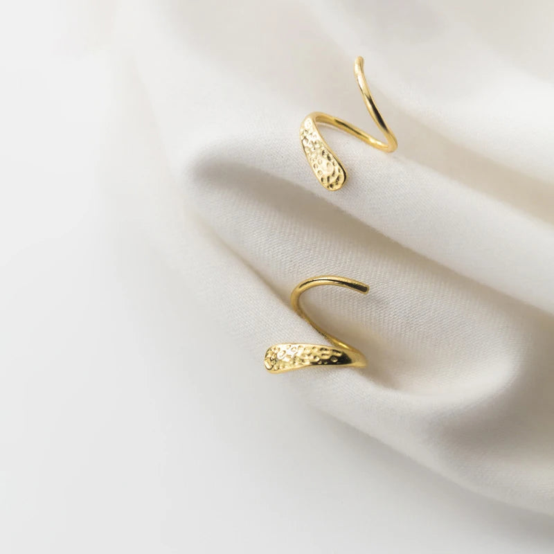 Sculptural stud earrings mixing silver earrings and gold earrings