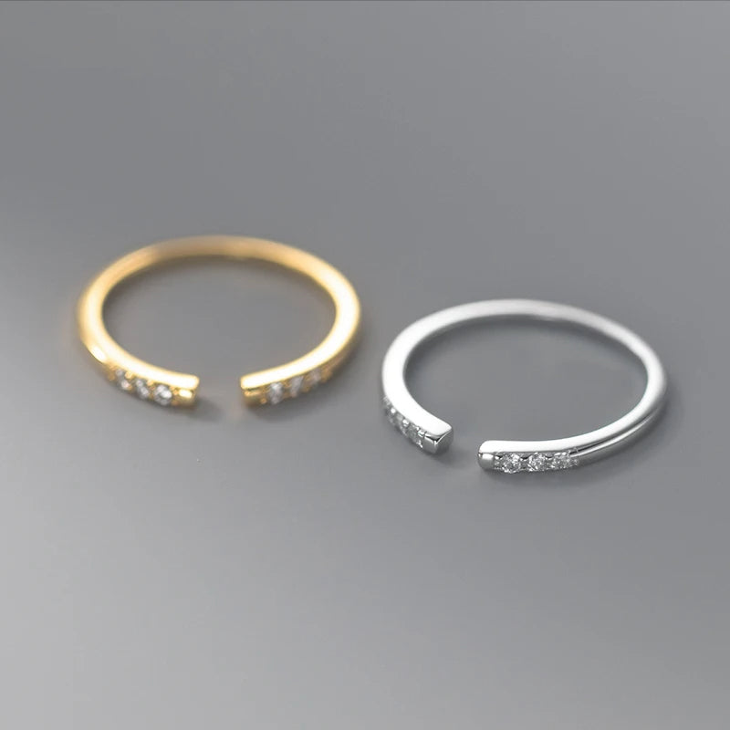 Minimal gold ring paired with a polished sterling silver ring look
