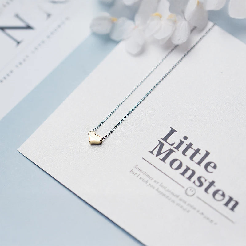 Long necklace style featuring a gold heart pendant