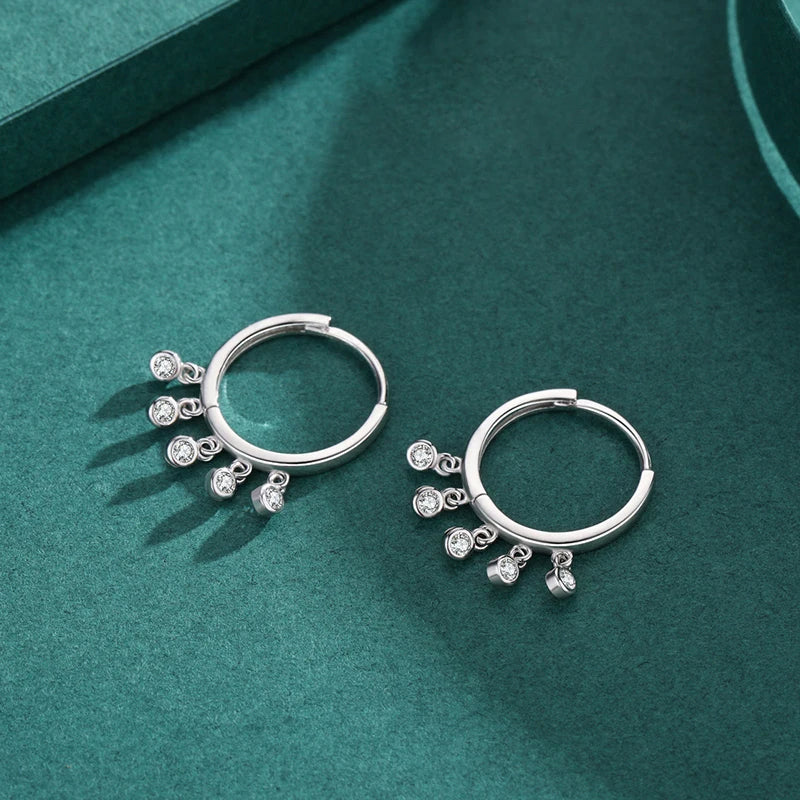 Sterling silver dangle earrings paired with sterling rings