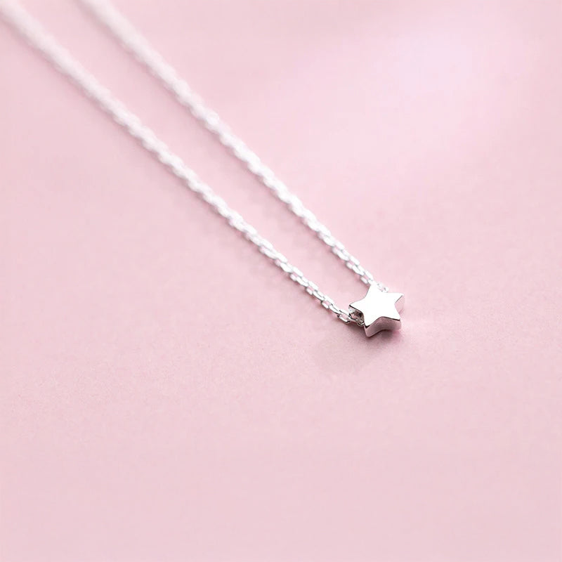 Silver womens necklace featuring a pendant necklace charm