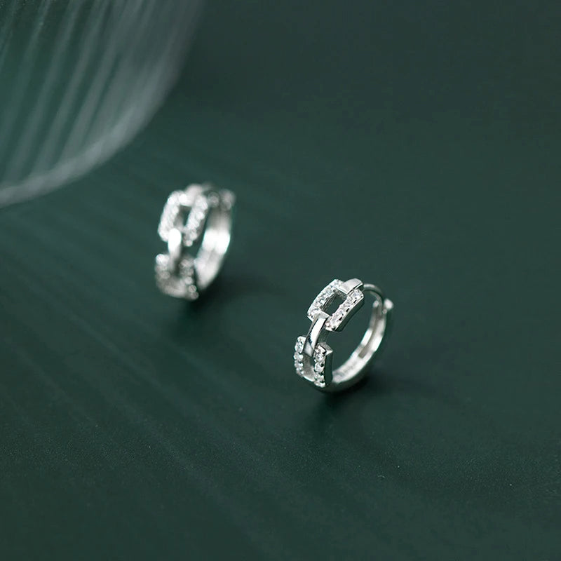Ear buckle earrings combining hoop style with clear CZ brilliance
