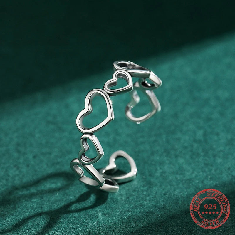 Sterling silver ring showing a polished heart and ring design