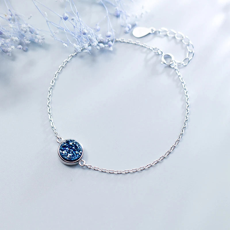 Sterling silver bracelet with blue crystal details styled as crystal jewelry