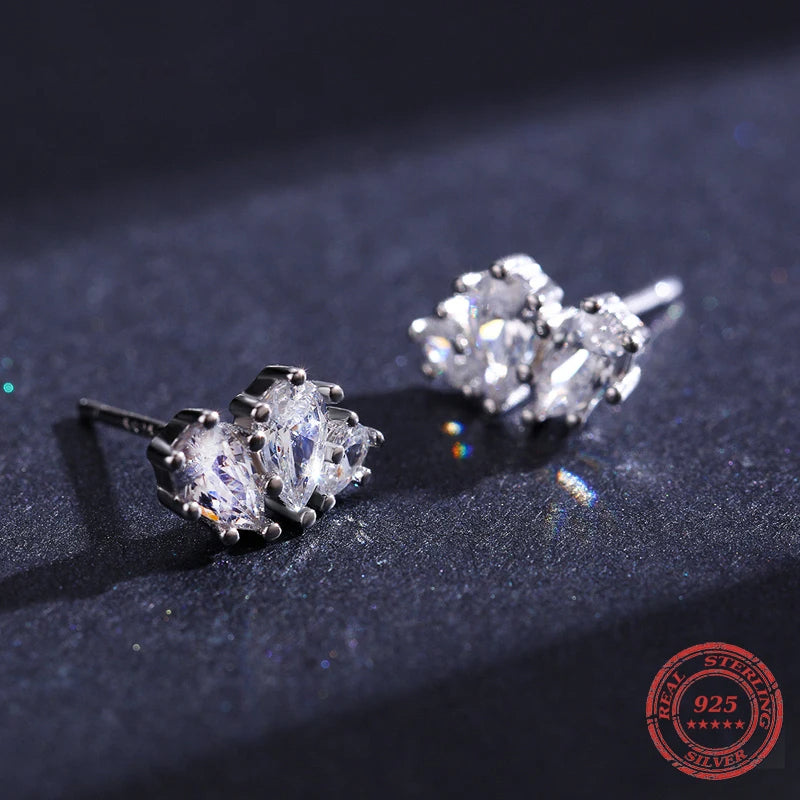 Minimal flatlay of ear rings and silver stud earrings together