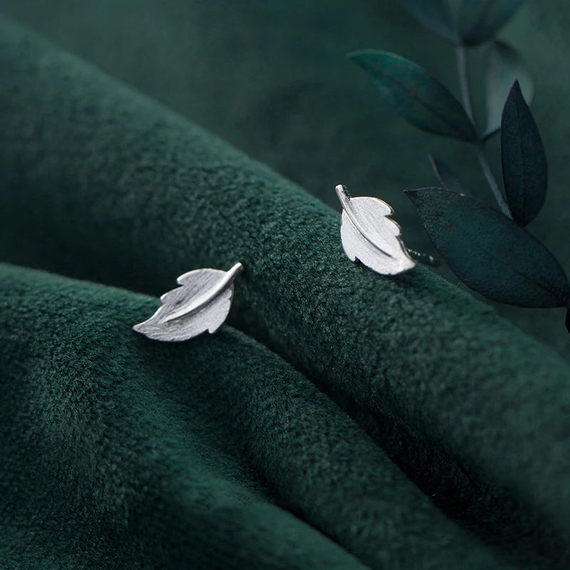Silver color leaf earrings paired with comfortable stud fit