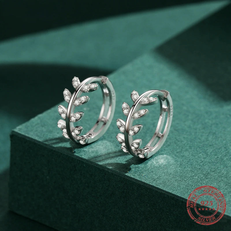 Silver hoop paired with delicate crystal leaves for subtle sparkle