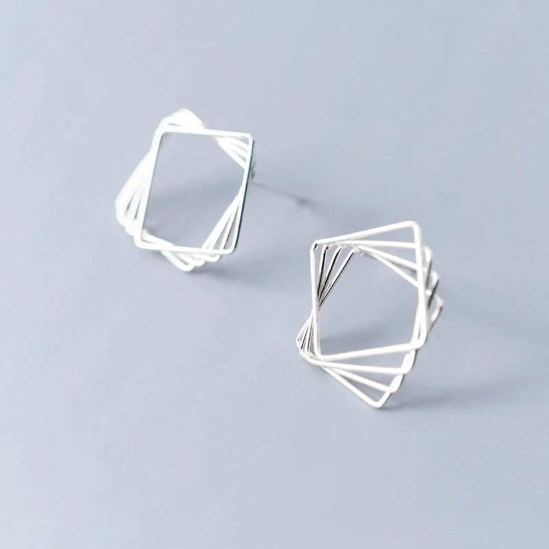 Close view of sterling silver earrings with geometric Triangle & Square design