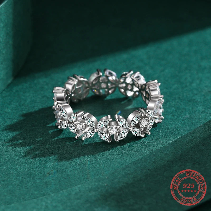 Sterling silver ring beside a card showing ring size from ring guidance