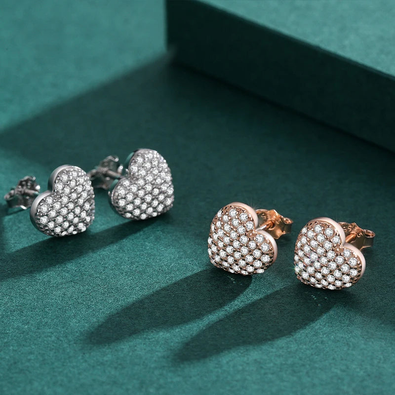 Close view of heart earrings paired with a sterling silver ring