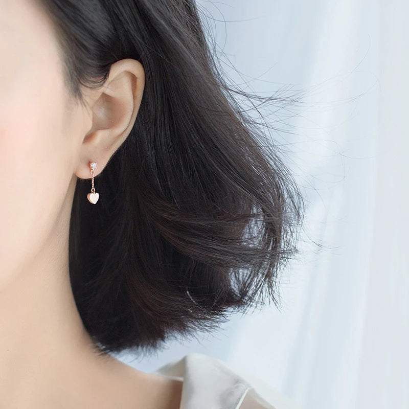 Elegant ear rings showing heart earrings with gentle dangle earrings movement
