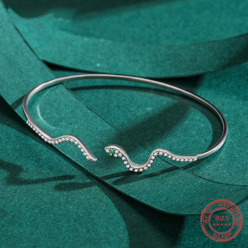 925 silver snake bracelet styled beside a slim silver bangle stack
