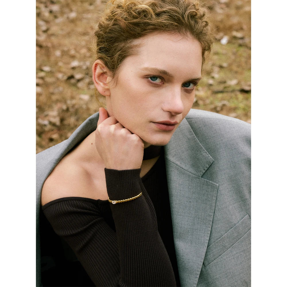 Elegant cuff bracelet styled like a gold bangle bracelet with zircon shine