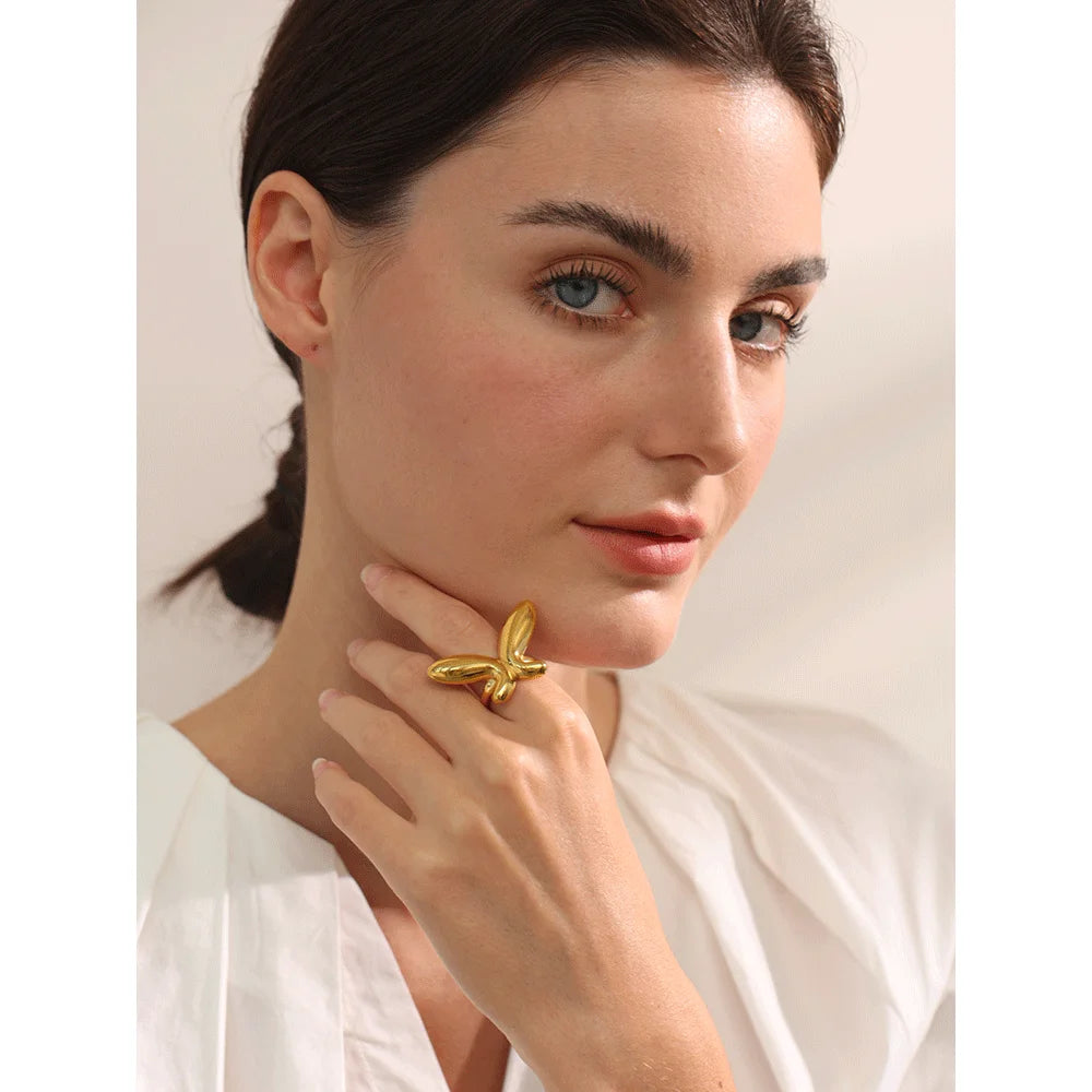 Close-up of butterfly open ring in polished gold plated finish