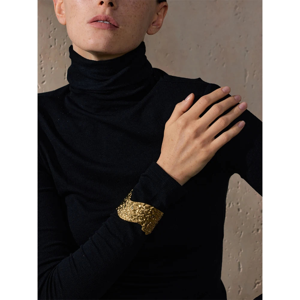 Bold gold jewelry cuff with hammered design
