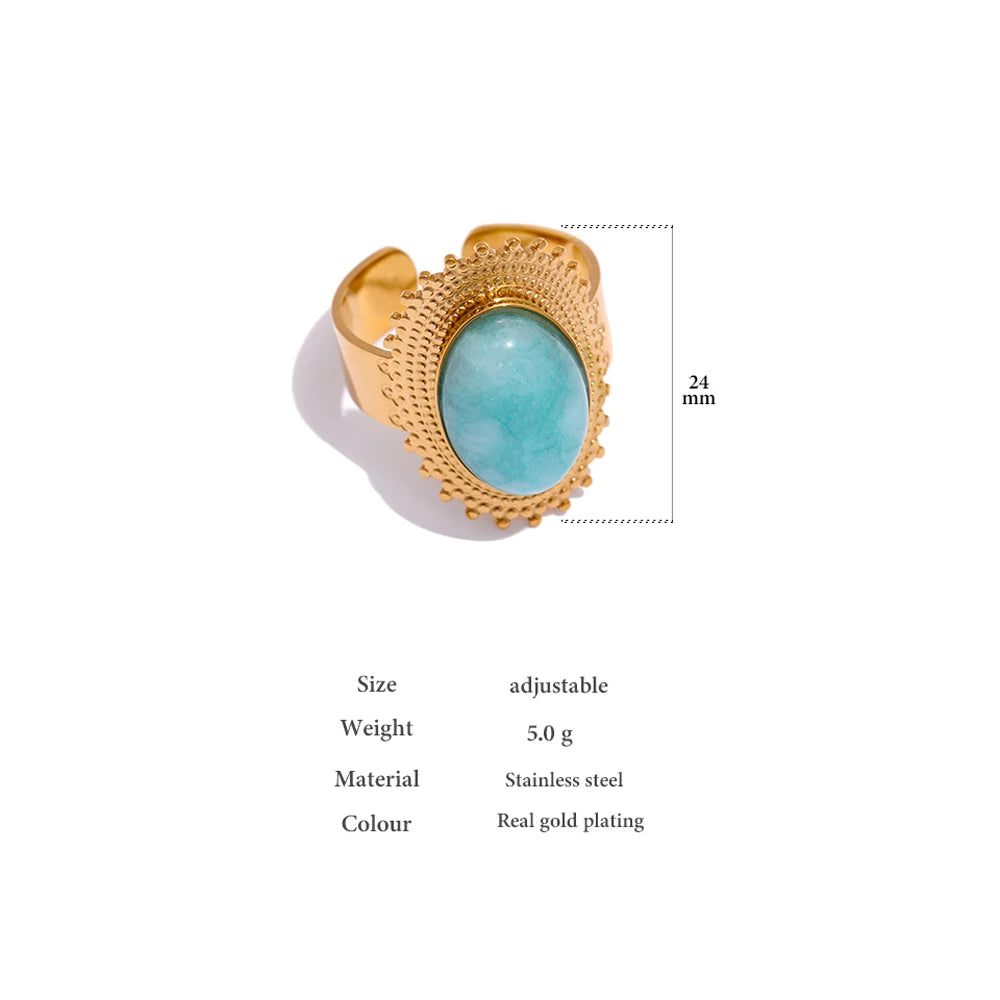 Ring with gold plated finish and prominent stone centerpiece on finger