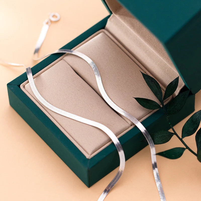 Jewelry sets flatlay showing sterling rings with a bracelet chain and women anklet