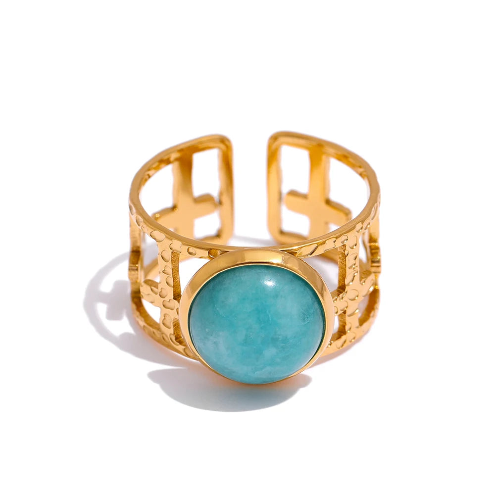 Turquoise stone centerpiece on a stainless steel ring with gold accents