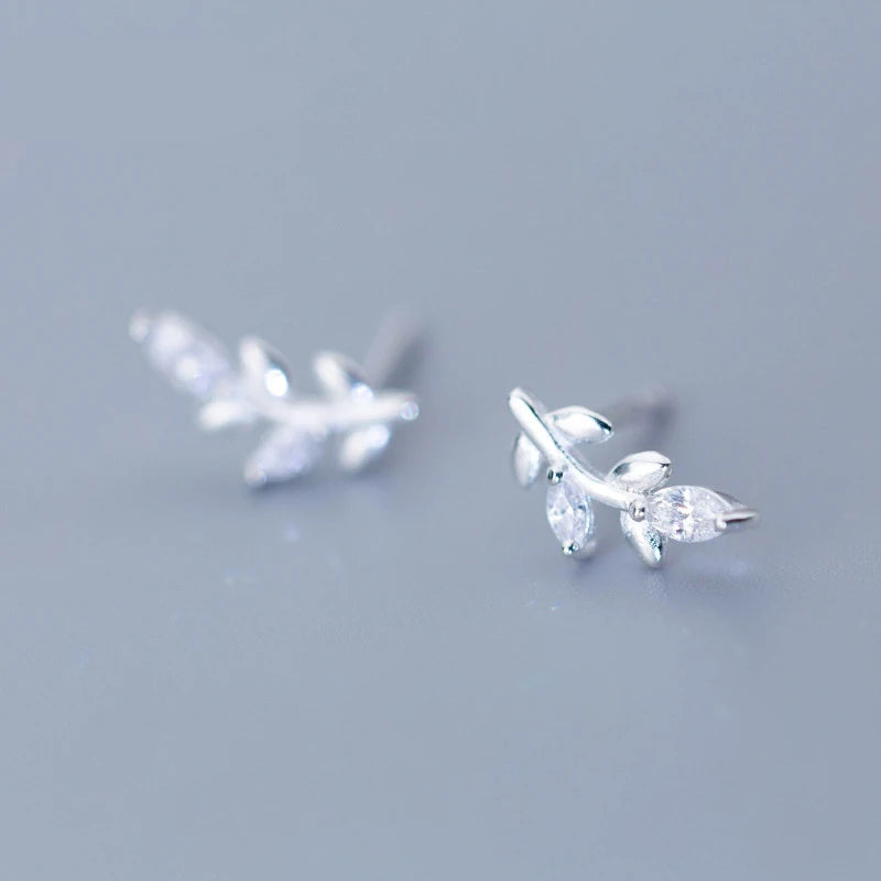 Silver color sterling silver earrings styled as women stud earrings