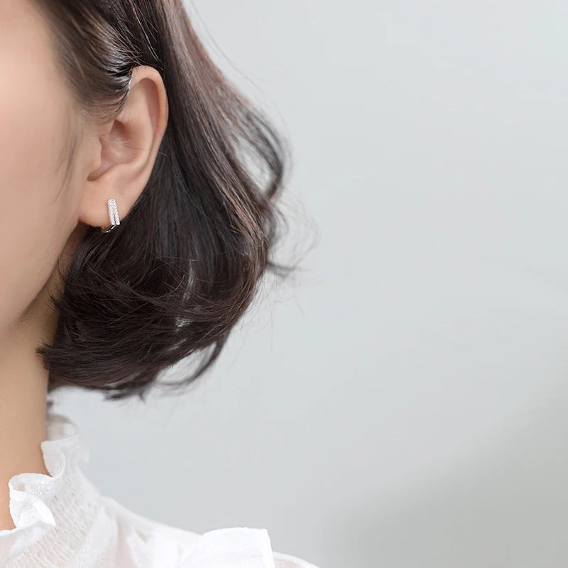 Sterling silver hoops featuring clear CZ on a square frame