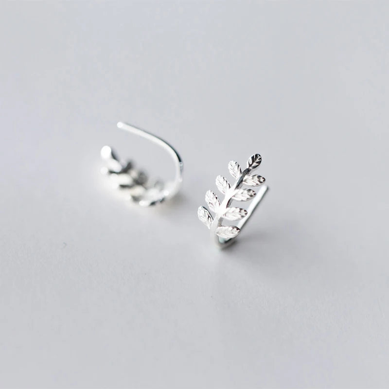 Silver hoops featuring a lucky charm leaf in sterling silver