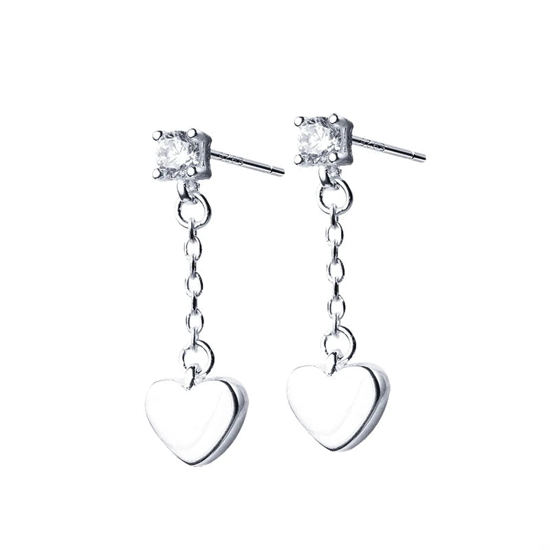 Heart earrings in silver color with a rose gold accent styled as dangle earrings