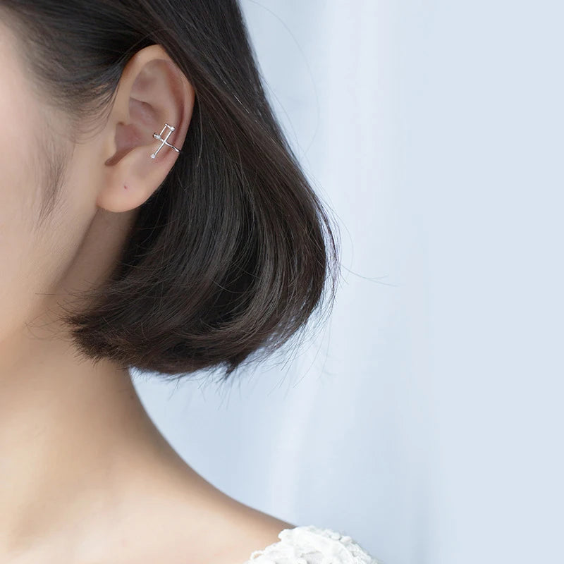 Close view of earrings that clip on with a smooth sterling silver finish