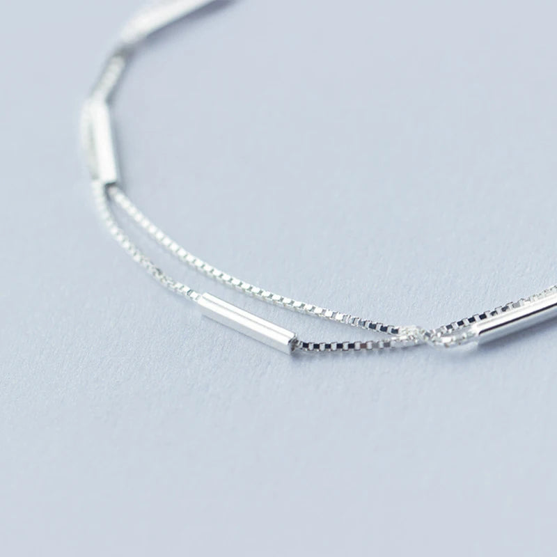 Close up of sterling silver bracelet showing geometric stick and silver color shine