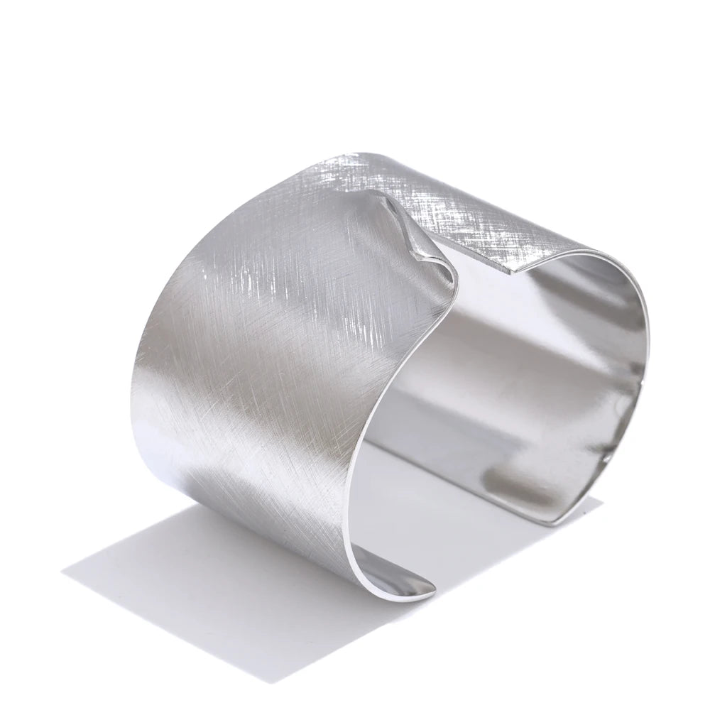 Lifestyle image pairing gold bangle bangles with a modern bracelet cuff