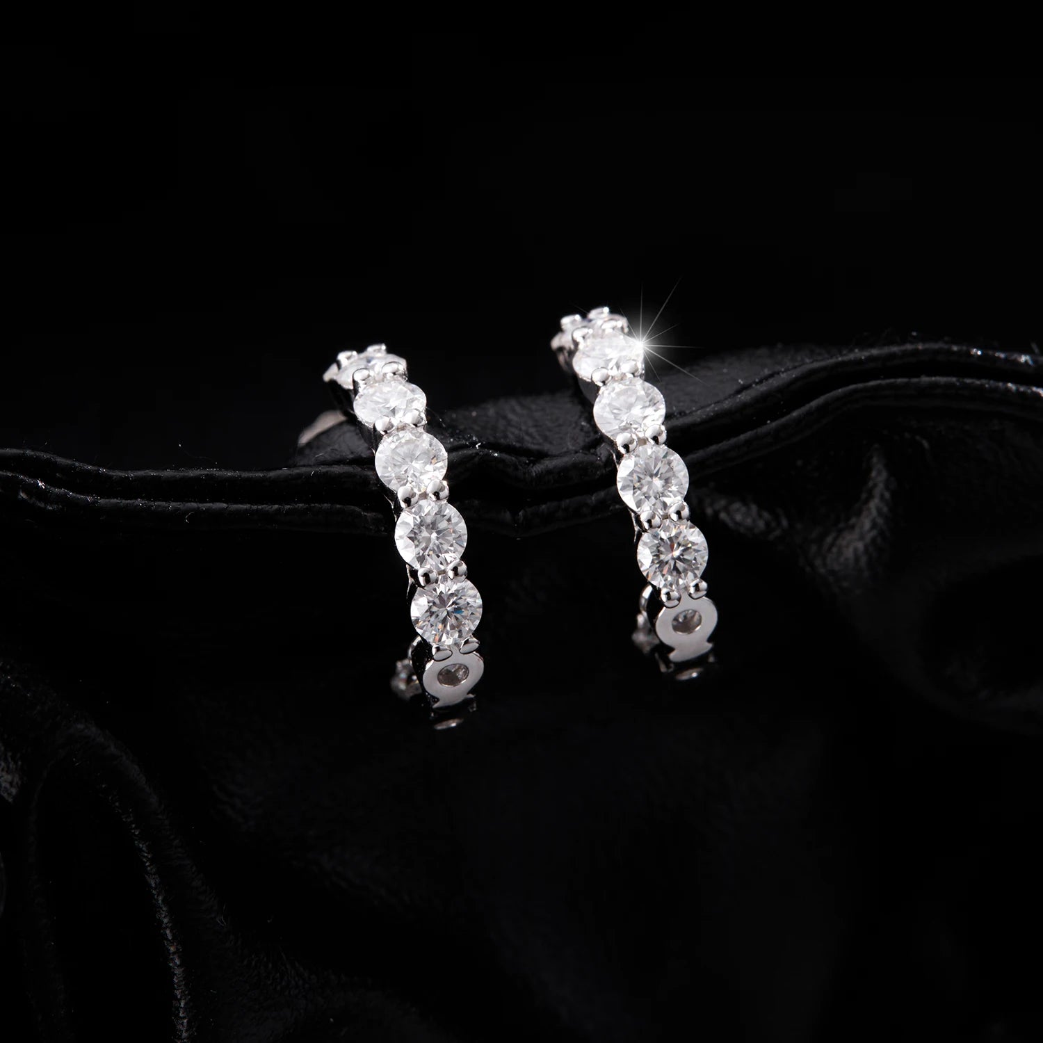 Close up of sterling silver hoop earrings showing moissanite jewelry brilliance