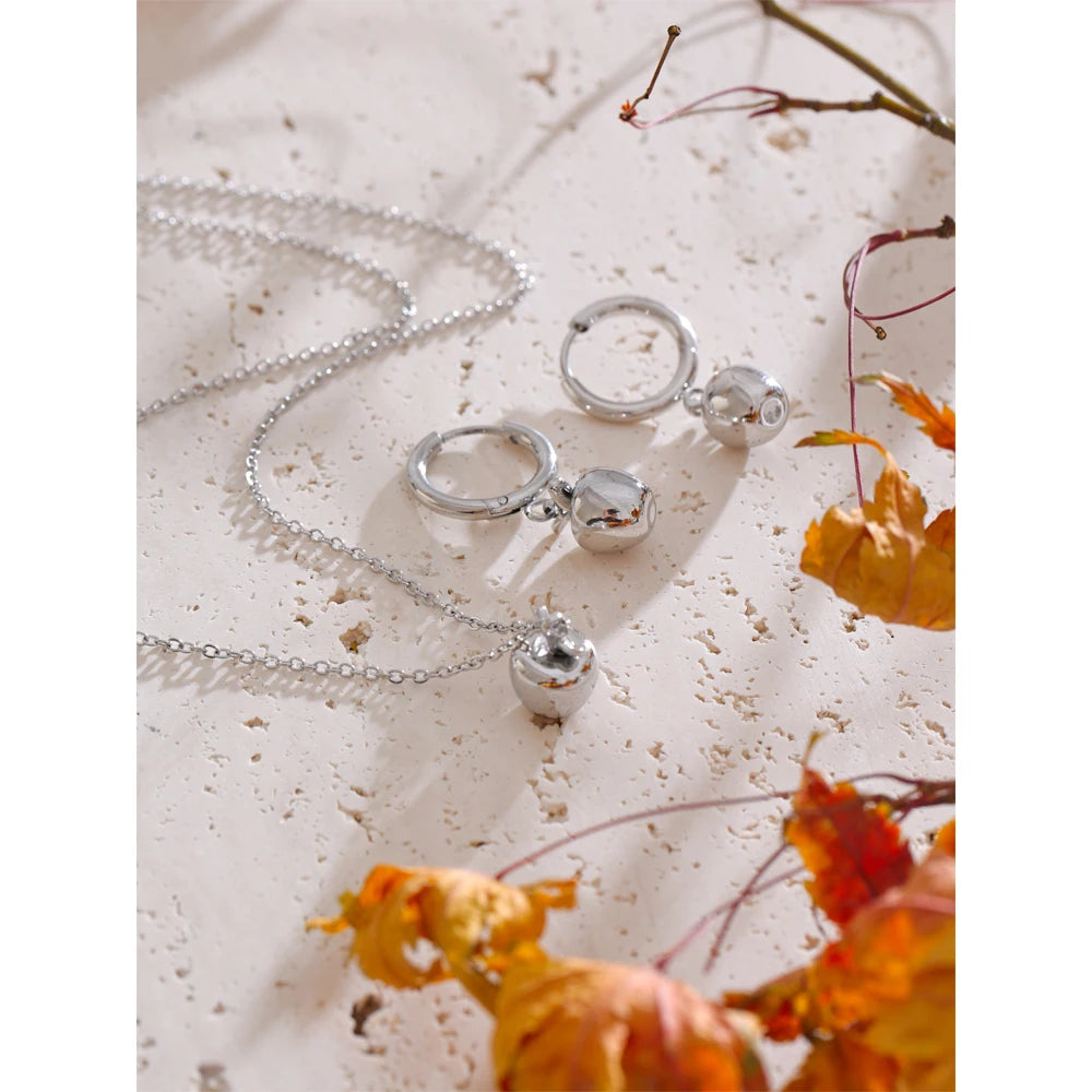 Close view of gold necklace gold paired with coordinated earrings