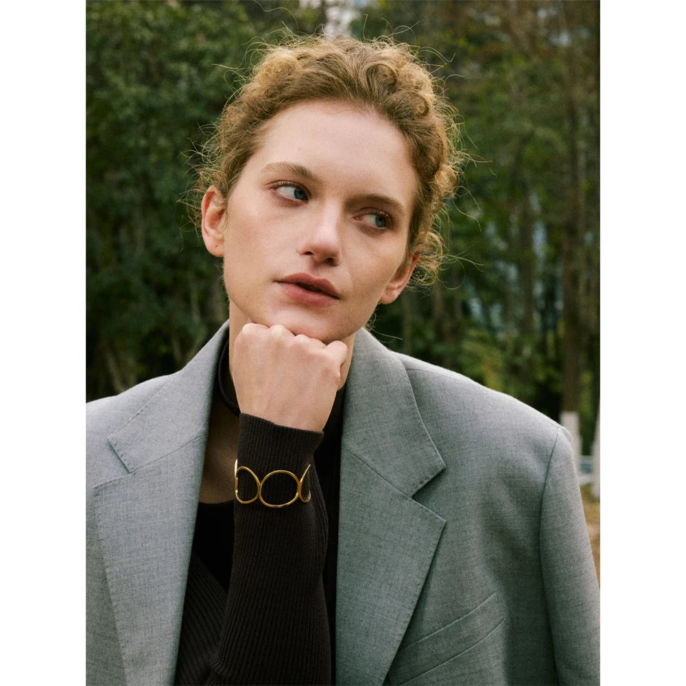 Clean cuff bracelet look layered as bangle and bangle with bracelet charm detail