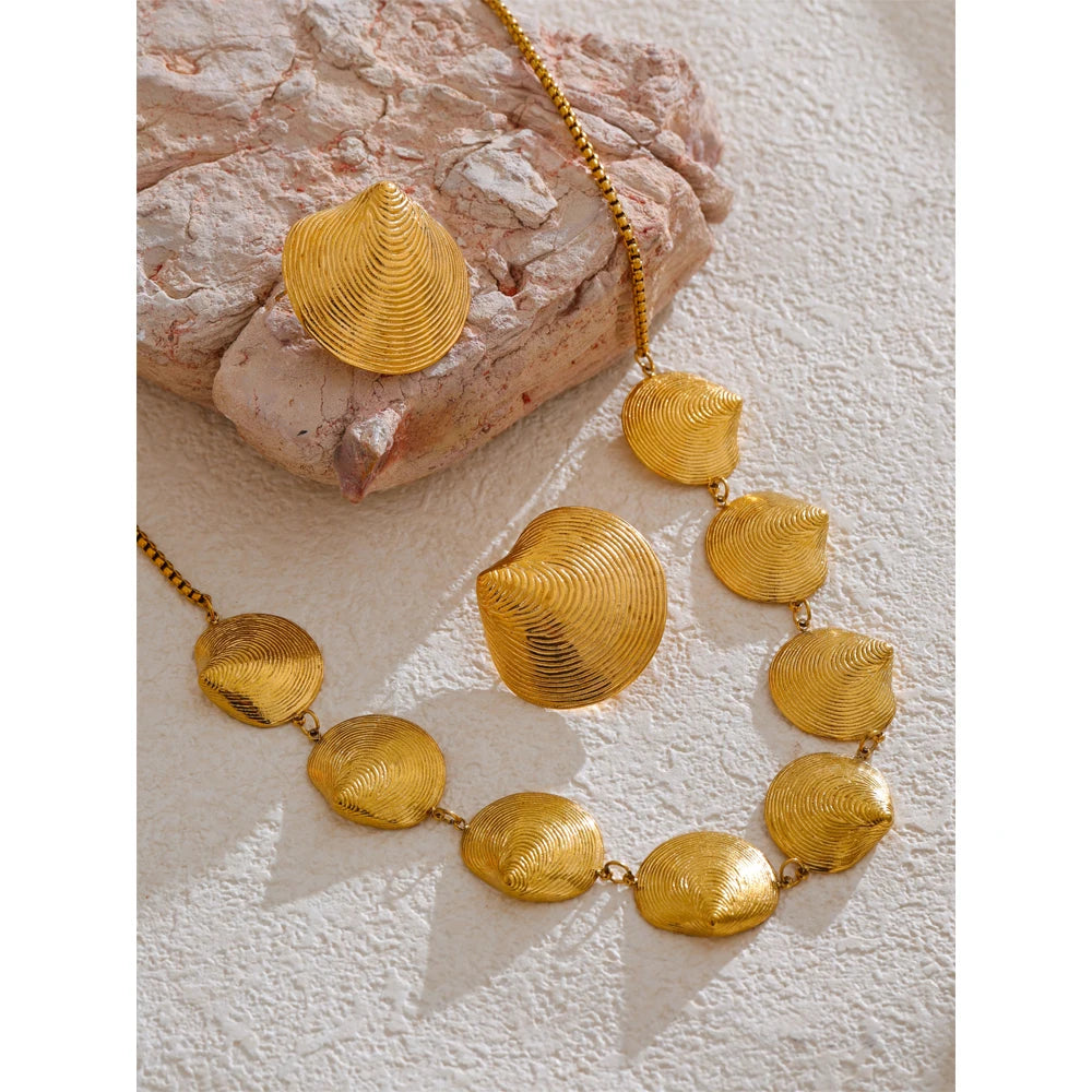 Elegant gold i necklace look paired with earrings and gold accents